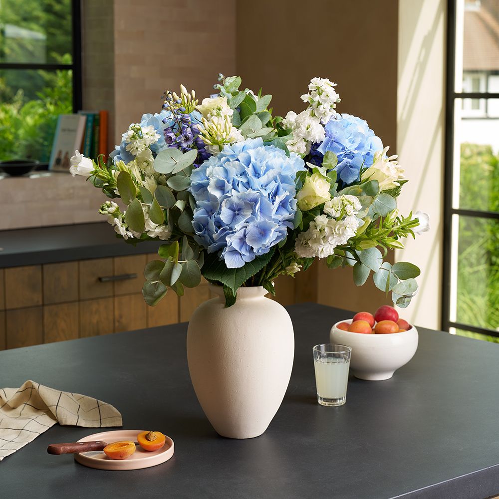 Positive Luxury bouquet of blue hydrangeas, delphiniums and white roses.