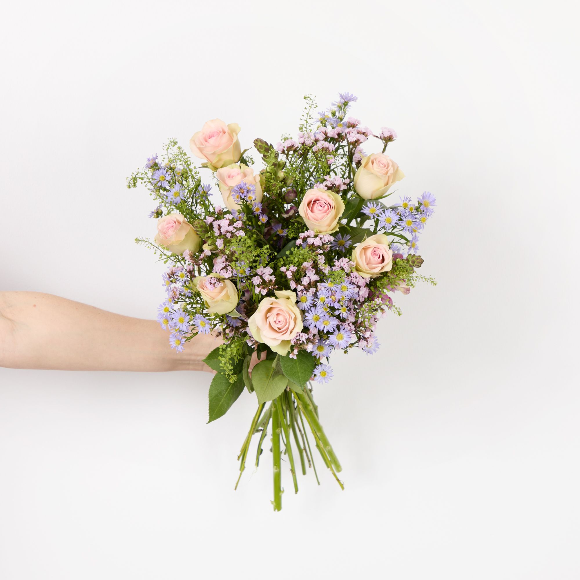 Pink roses, lilac asters, lilac antirrhinums, pink statice and greenbell