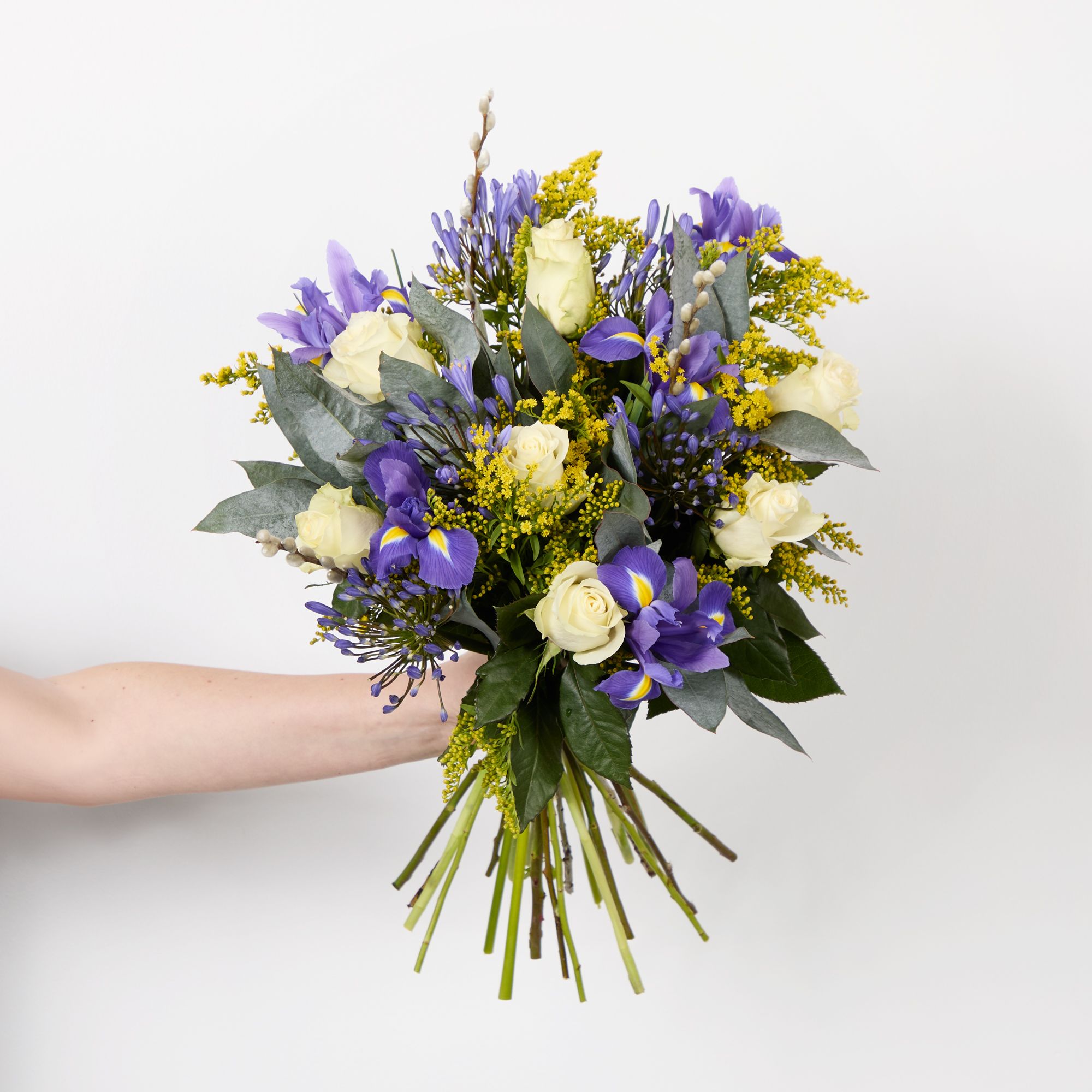 White roses, pussy willow, blue agapanthus, blue irises, solidago and eucalyptus robusta