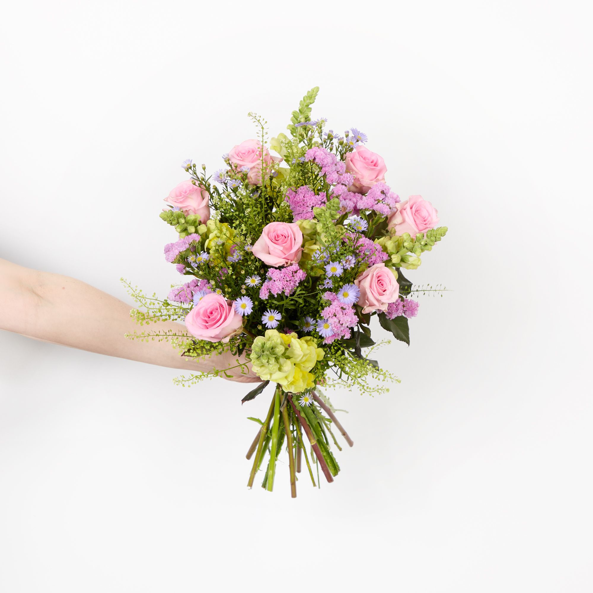 Pink roses, yellow antirrhinums, lilac asters, pink statice and greenbell