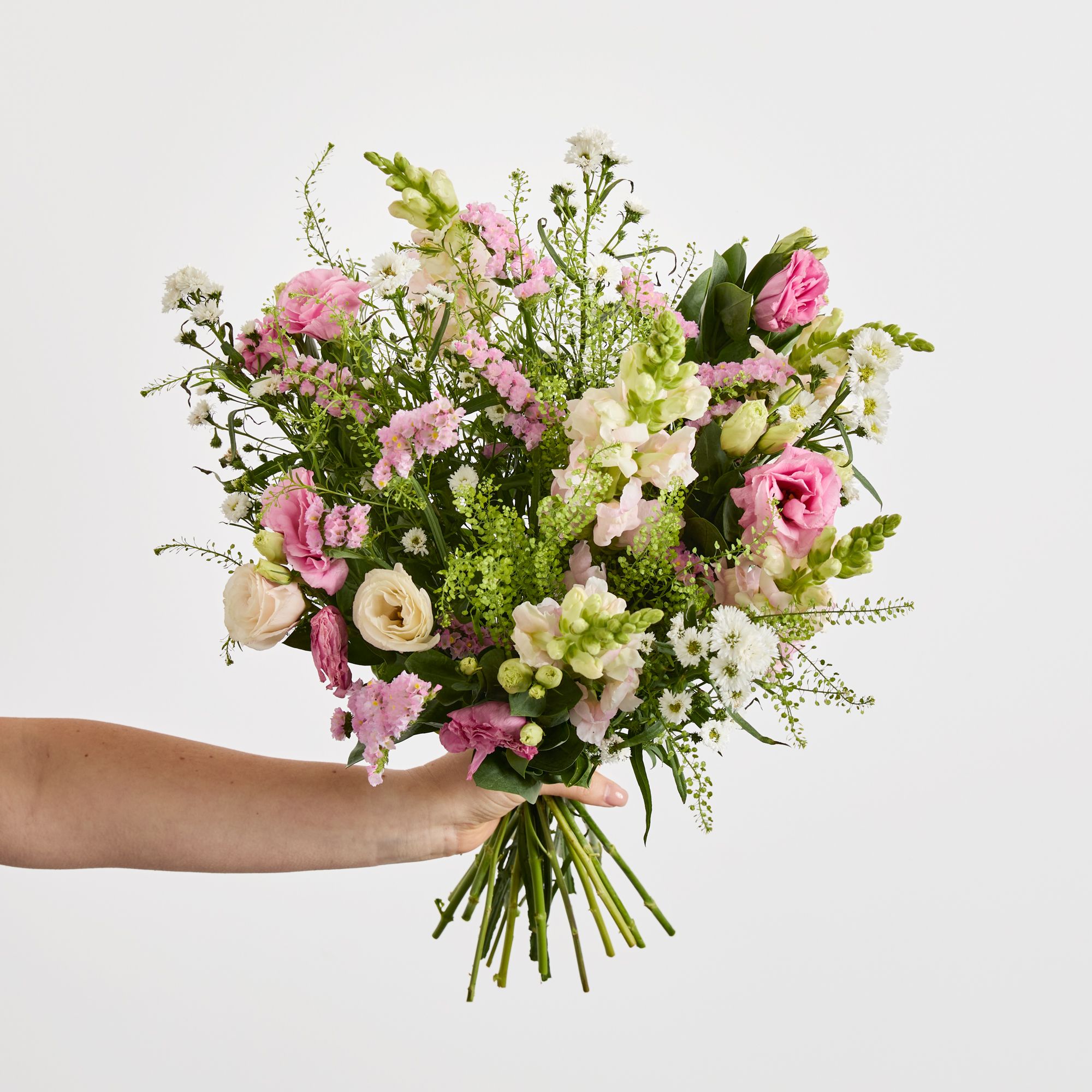 Pink lisianthus, white asters, pink statice, pink antirrhinums and greenbell