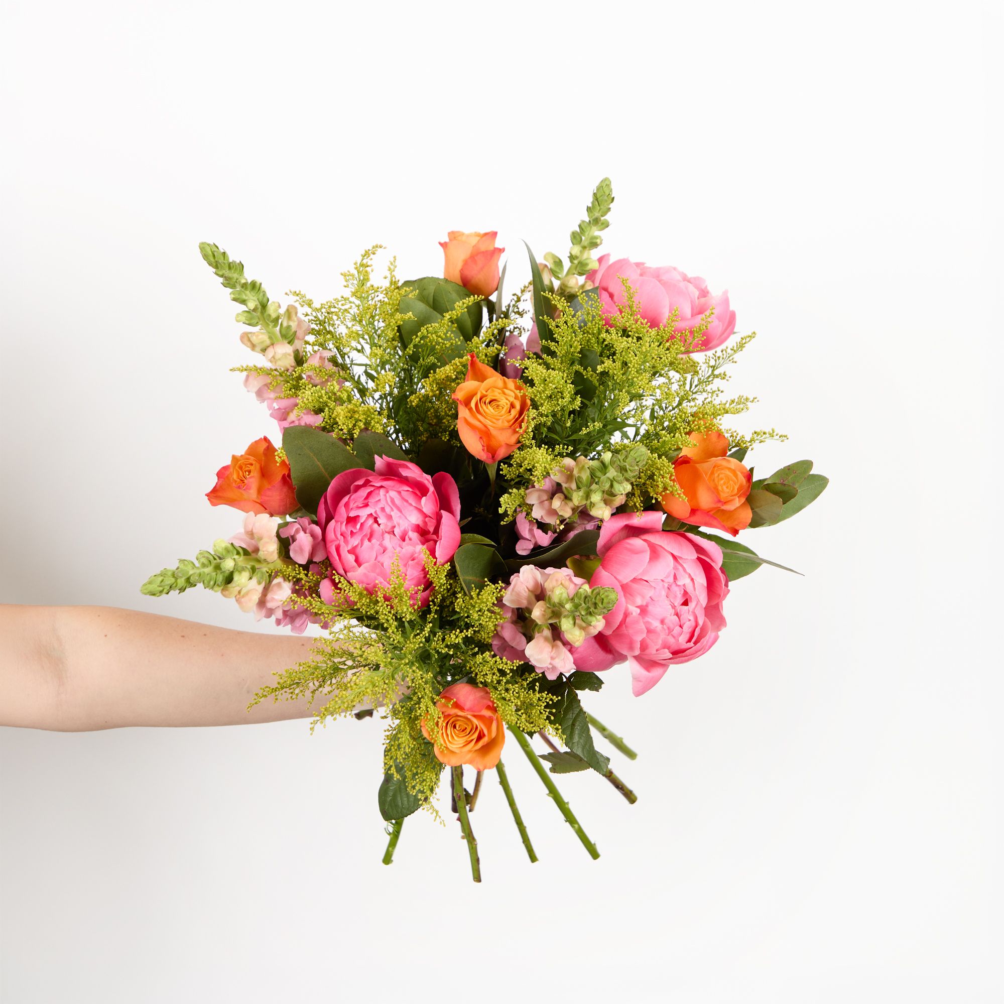 'Coral Sunset' peonies, orange roses, pink antirrhinums, solidago and eucalyptus robusta
