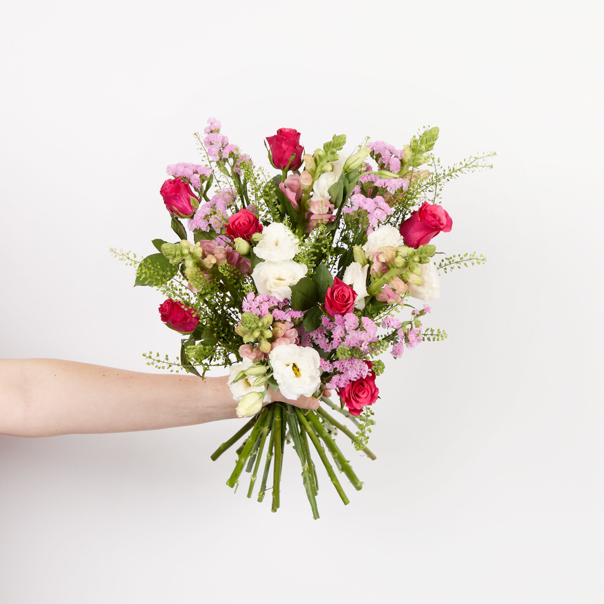 Cerise roses, white lisianthus, pink antirrhinums, pink statice and greenbell