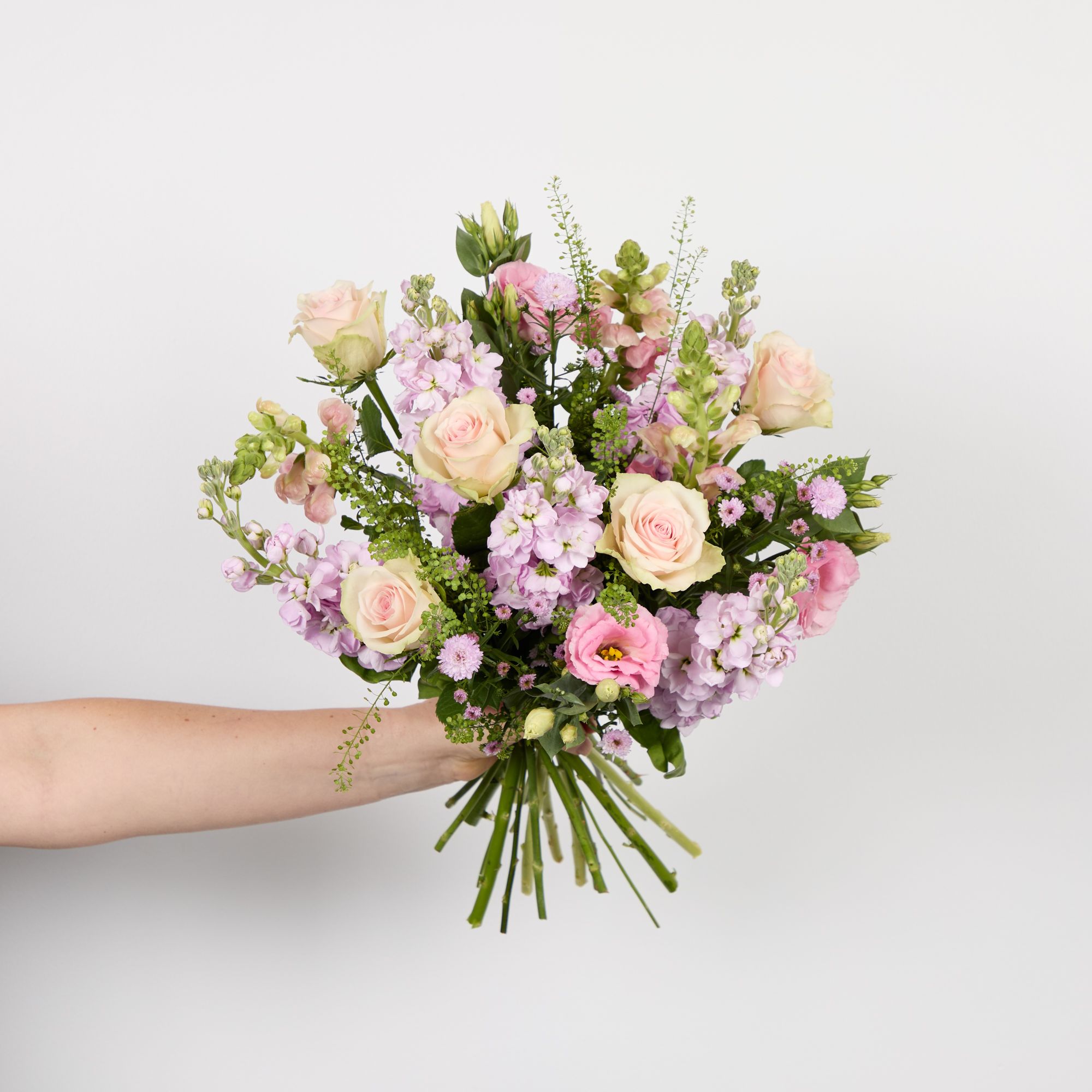 Pink stocks, pink roses, pink antirrhinums, pink asters, pink lisianthus and greenbell