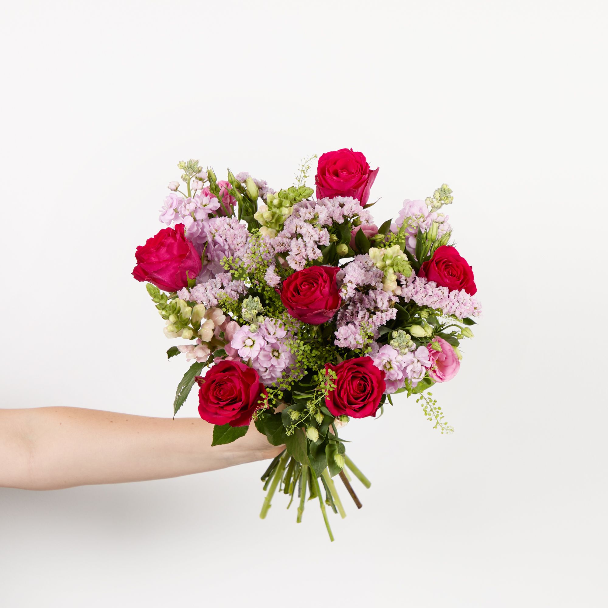 Cerise roses, pink antirrhinums, pink lisianthus, pink statice, pink stocks and greenbell