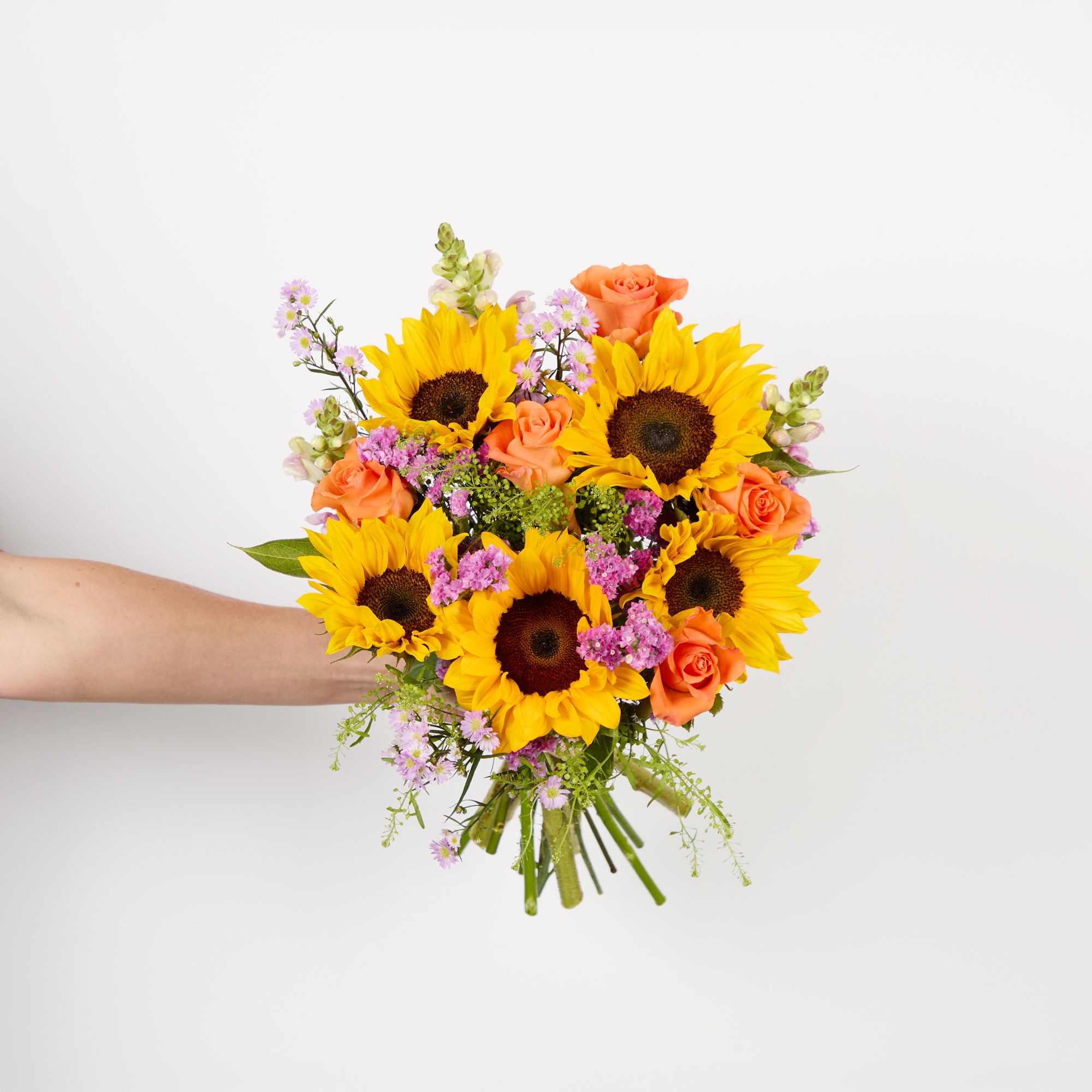 Sunflowers, lilac antirrhinums, pink asters, orange roses, pink statice and greenbell