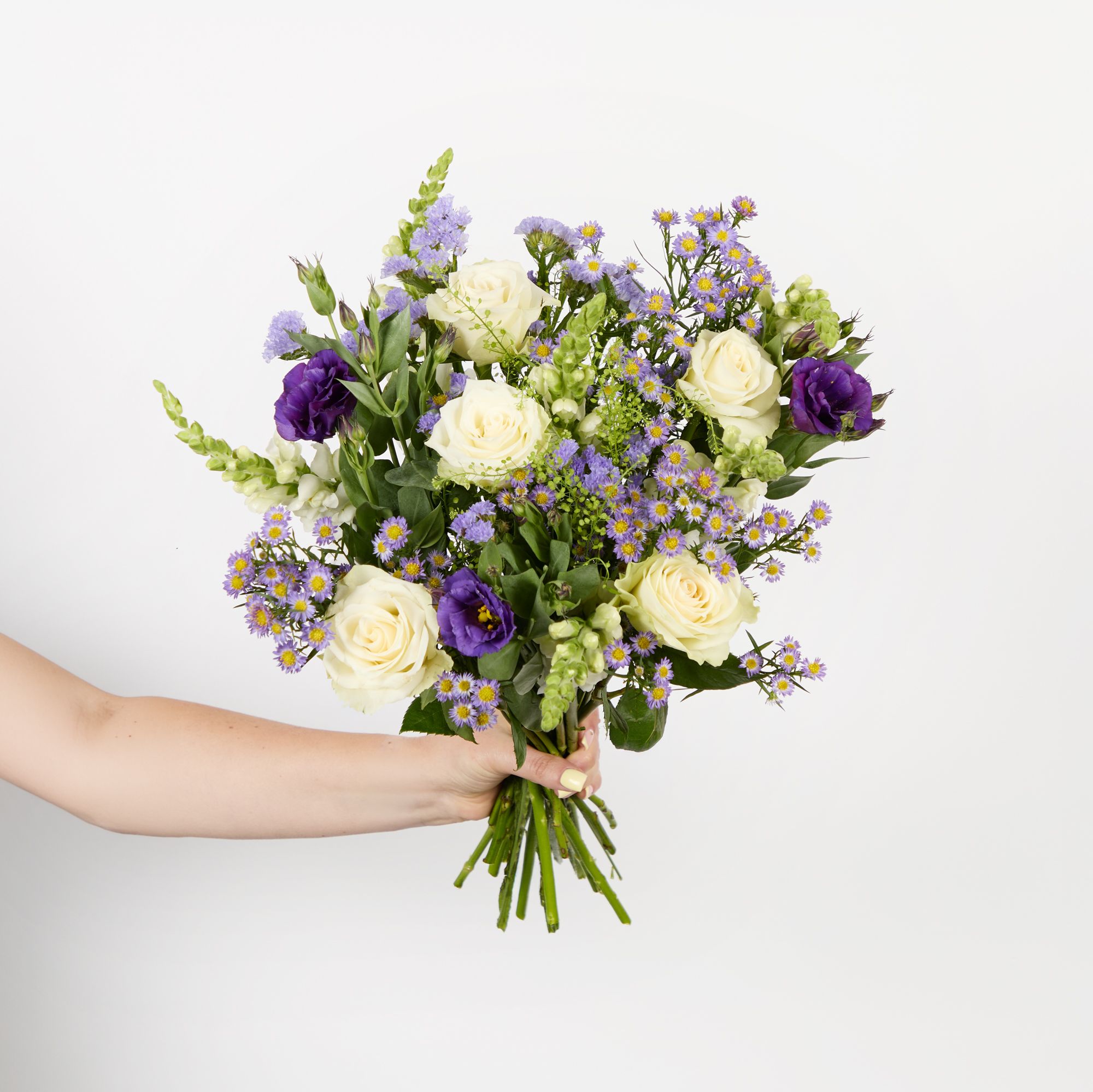 White roses, white antirrhinums, purple lisianthus, purple asters, lilac statice and greenbell
