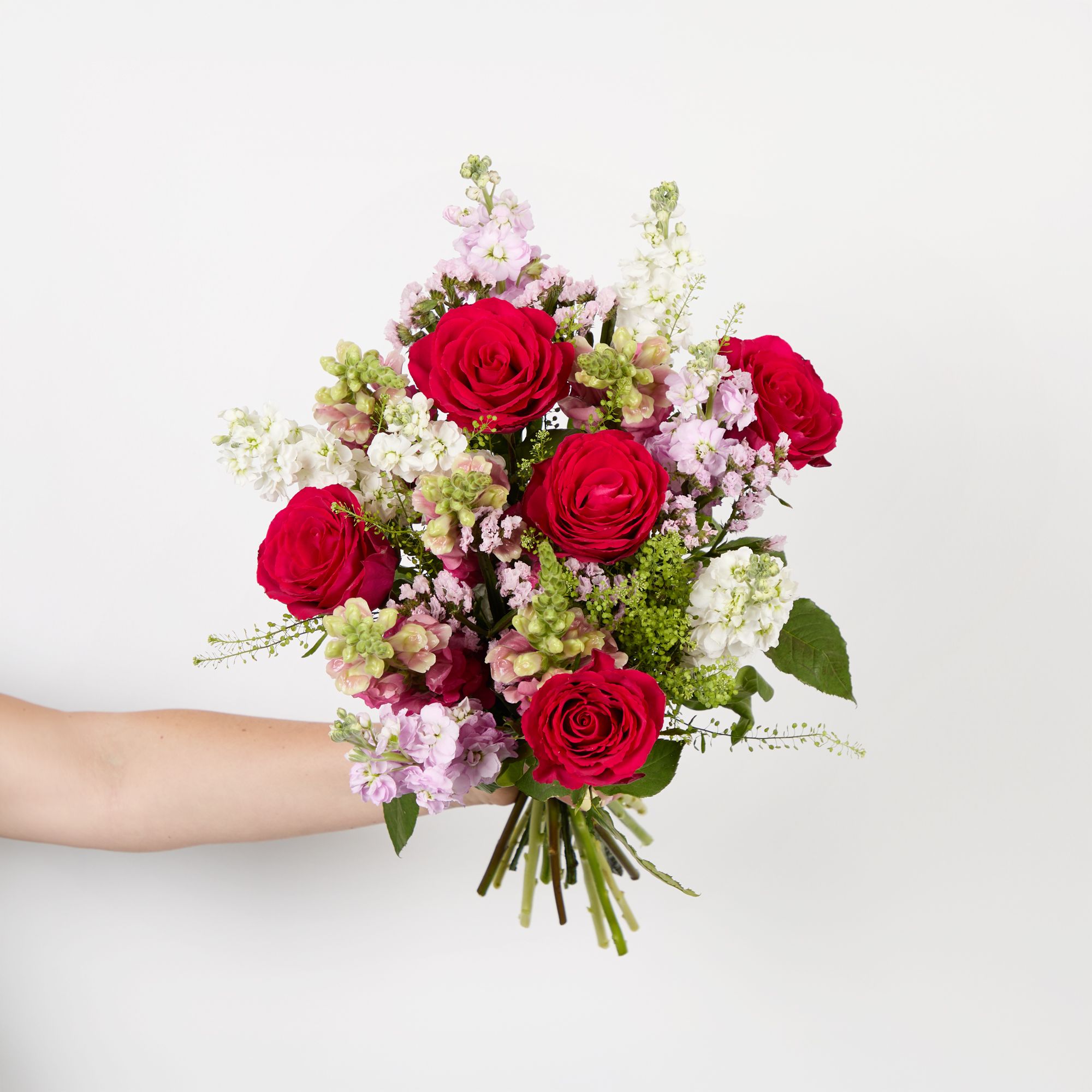 Cerise roses, pink statice, pink antirrhinums, light pink stocks, white stocks and greenbell