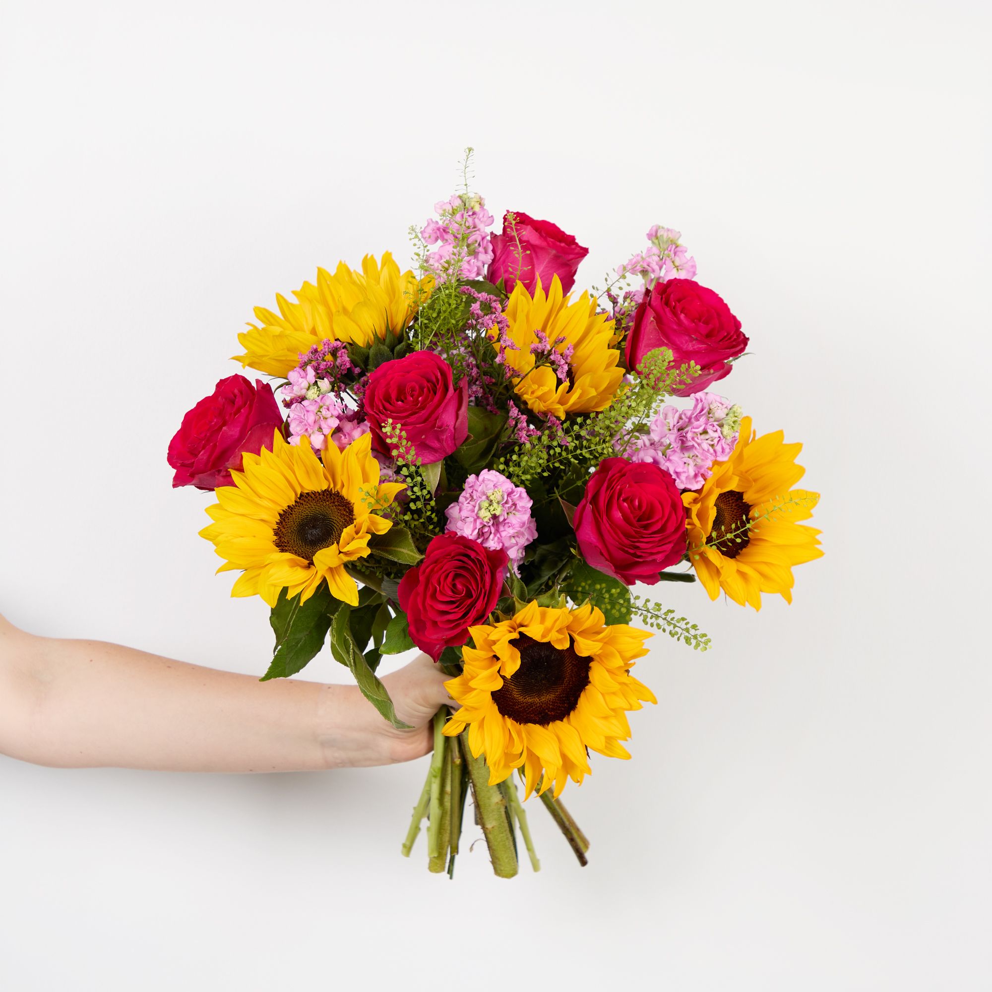 Sunflowers, cerise roses, dark pink limonium, pink stocks and greenbell