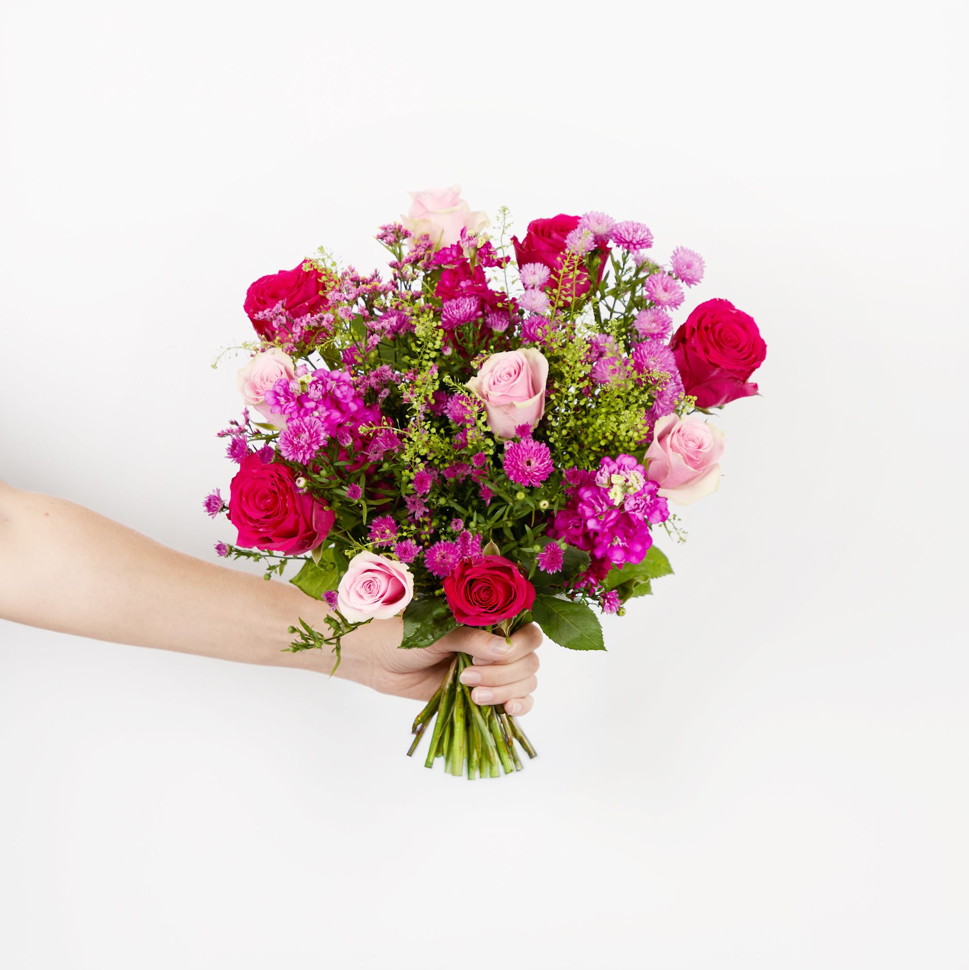 Pink and cerise roses, cerise asters, cerise stocks, cerise limonium and greenbell