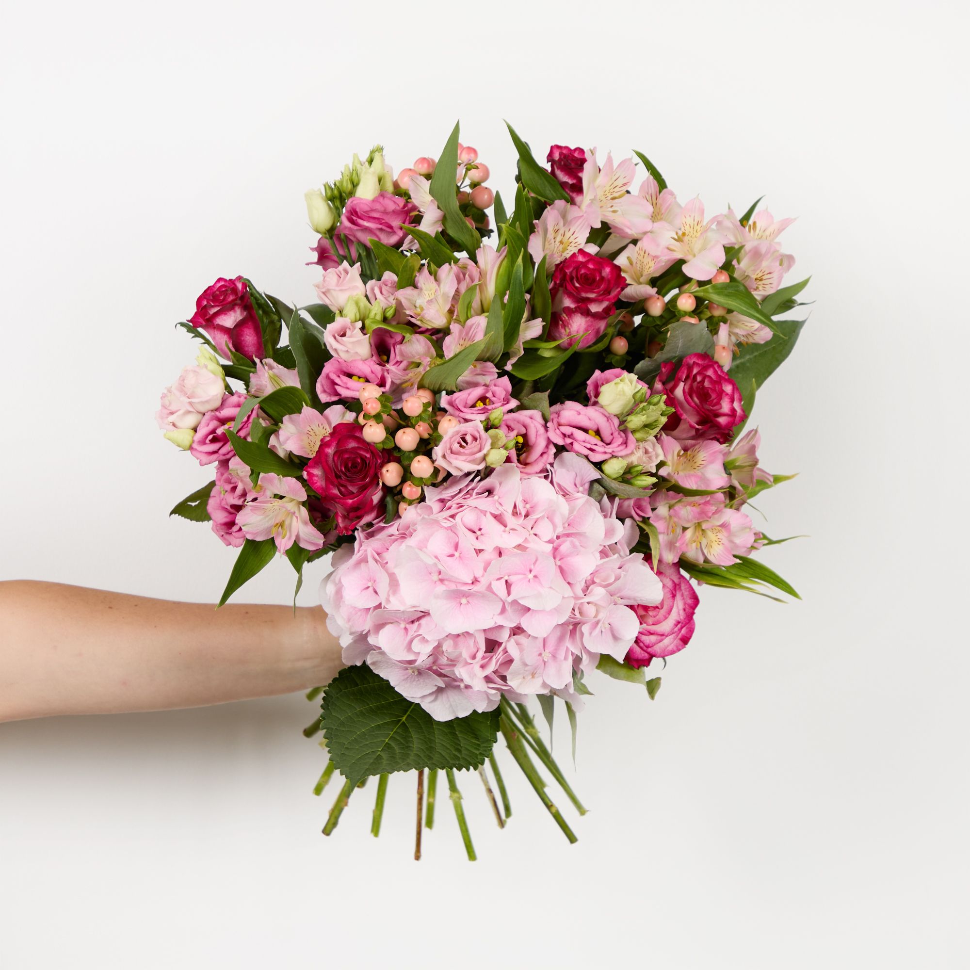 Pink hydrangea, pink roses, lisianthus, pink hypericum, pink alstroemeria and eucalyptus robusta