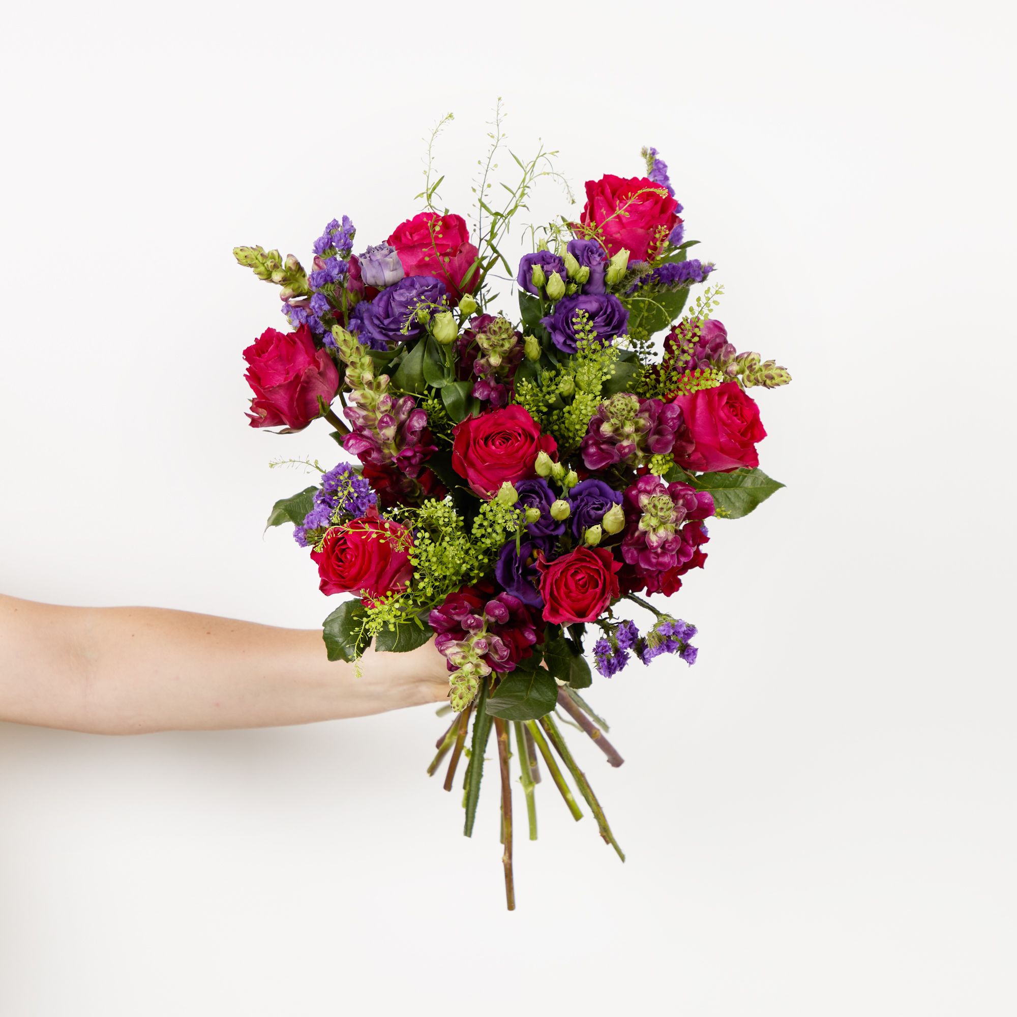 Cerise roses, purple lisianthus, red antirrhinums, purple statice and greenbell