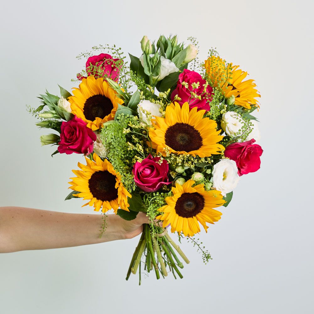 UK-grown sunflowers, cerise roses, white lisianthus, yellow limonium and greenbell