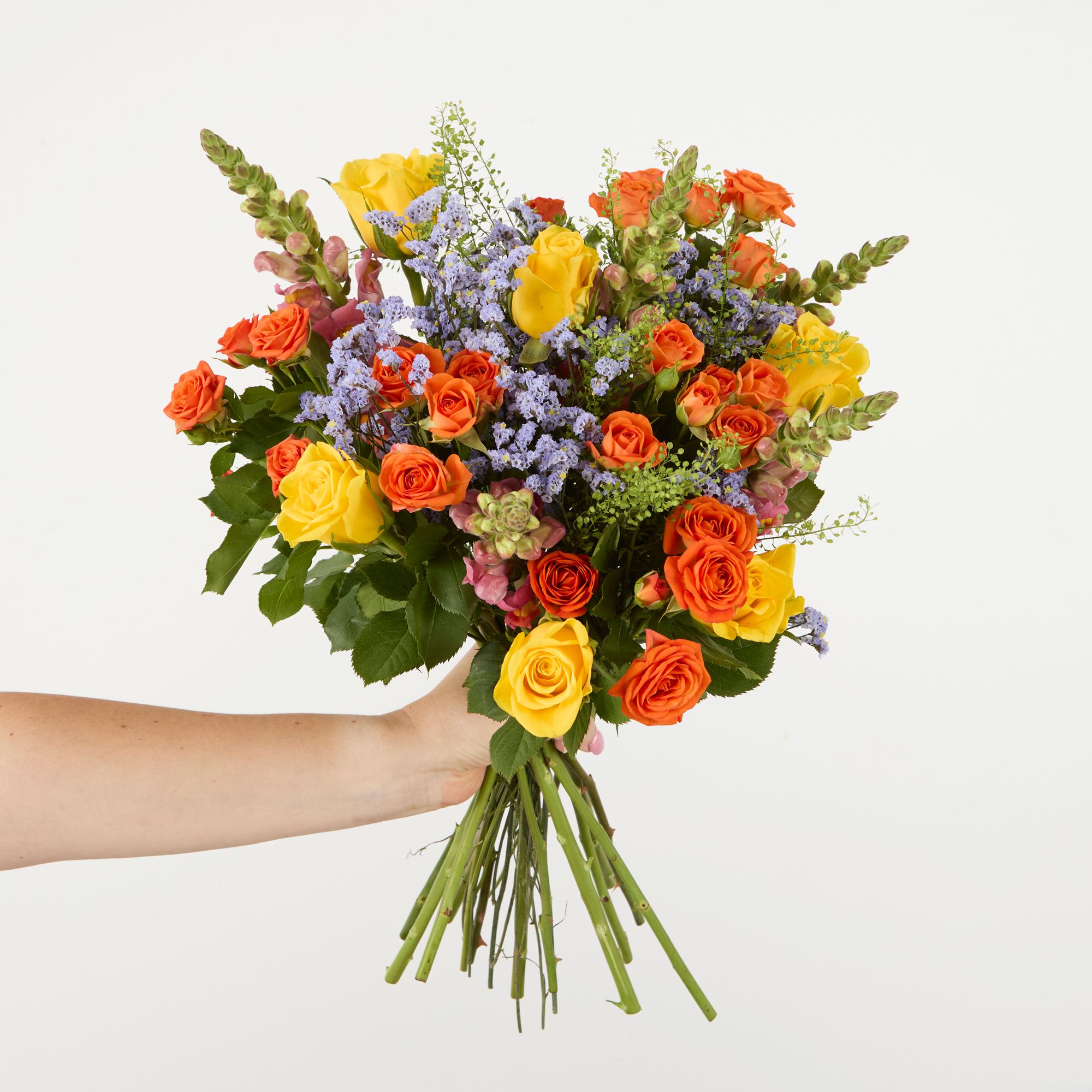 Yellow roses, orange antirrhinums, orange spray roses, lavender limonium and greenbell