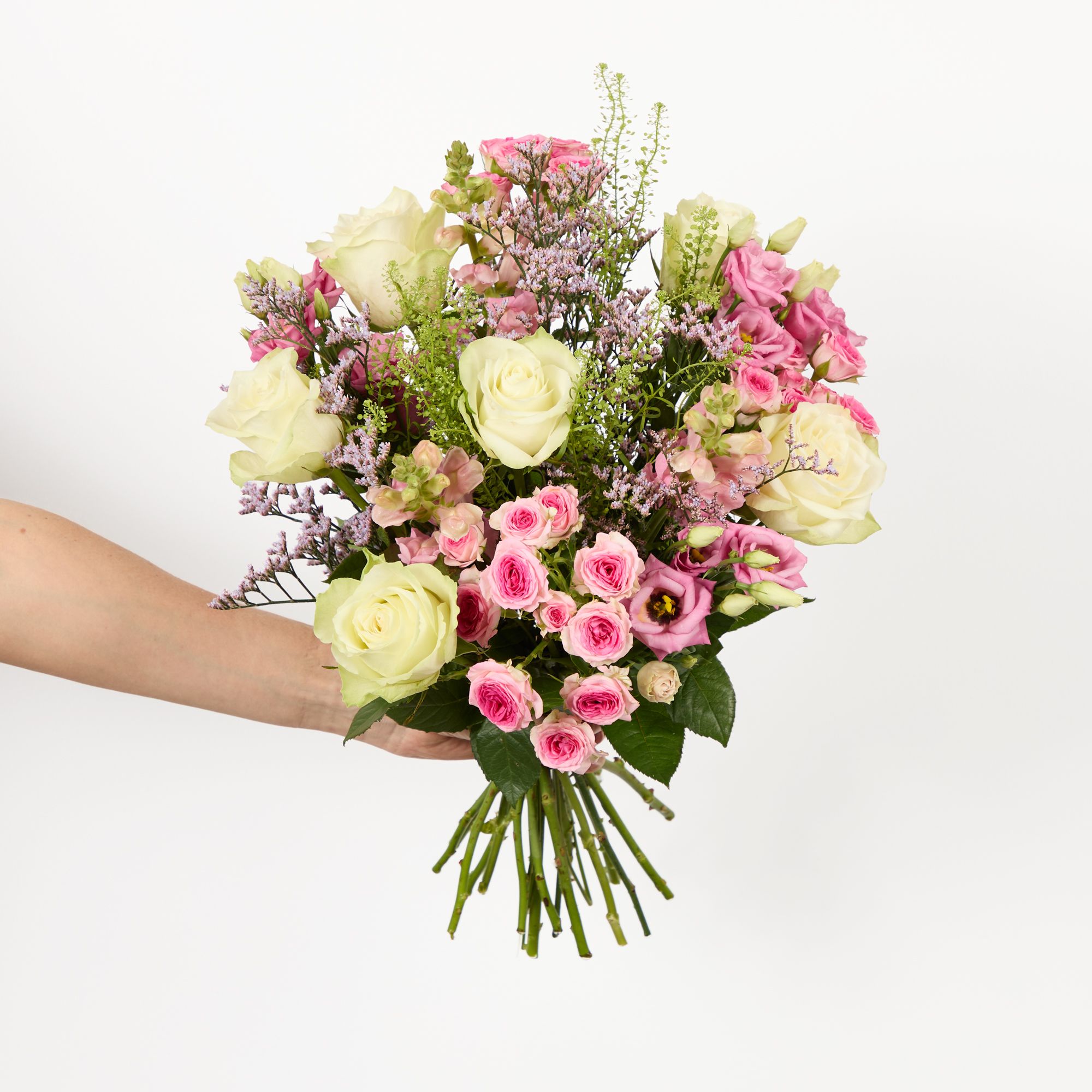White roses, pink lisianthus, pink antirrhinums, pink ‘Tralala’ roses, pink limonium and greenbell