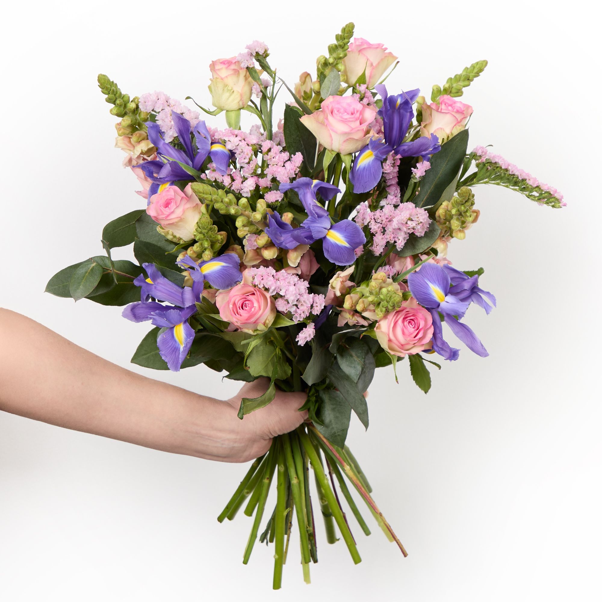 Blue irises, pink roses, pink antirrhinum, pink statice and eucalyptus robusta