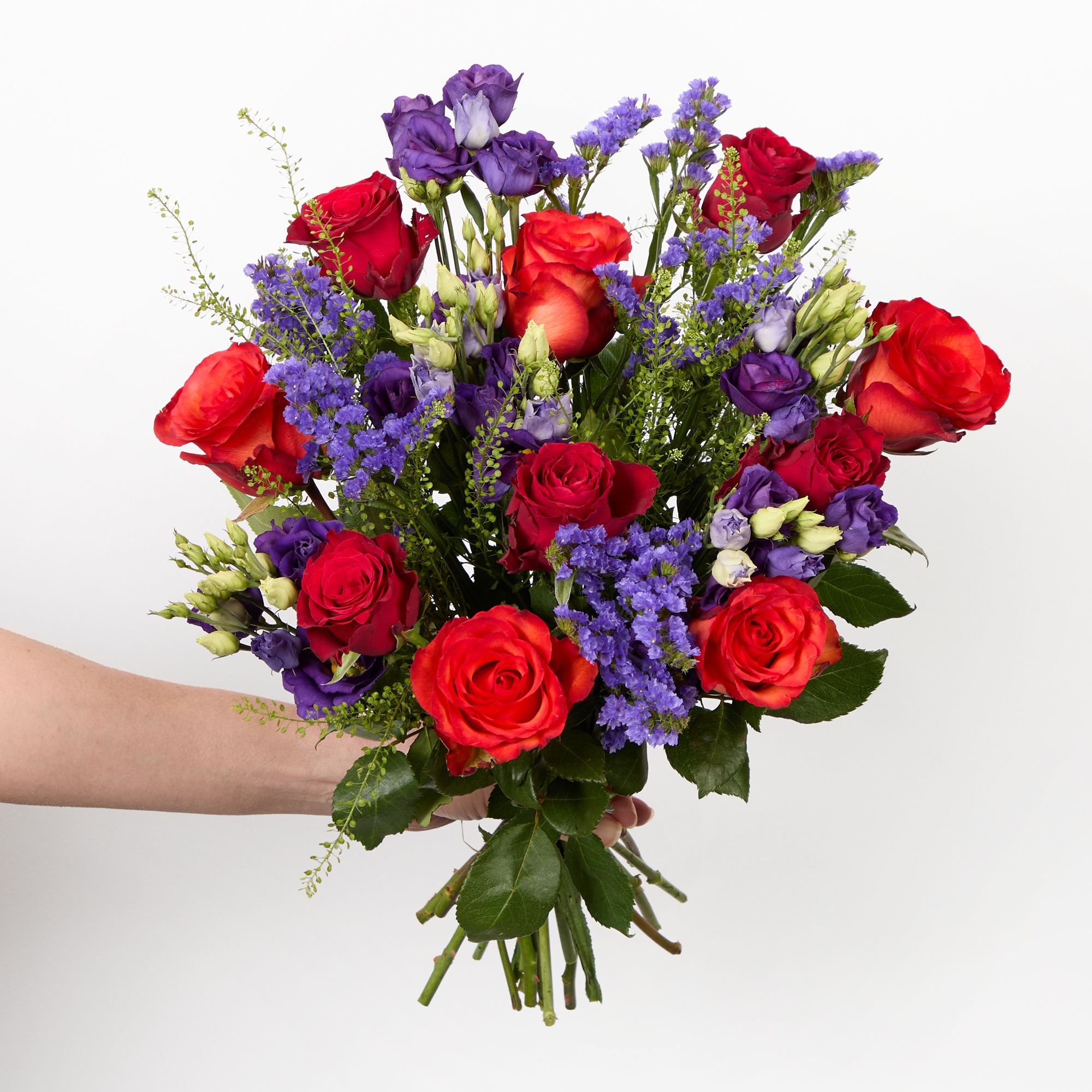 Orange and red roses, purple lisianthus, purple statice and greenbell