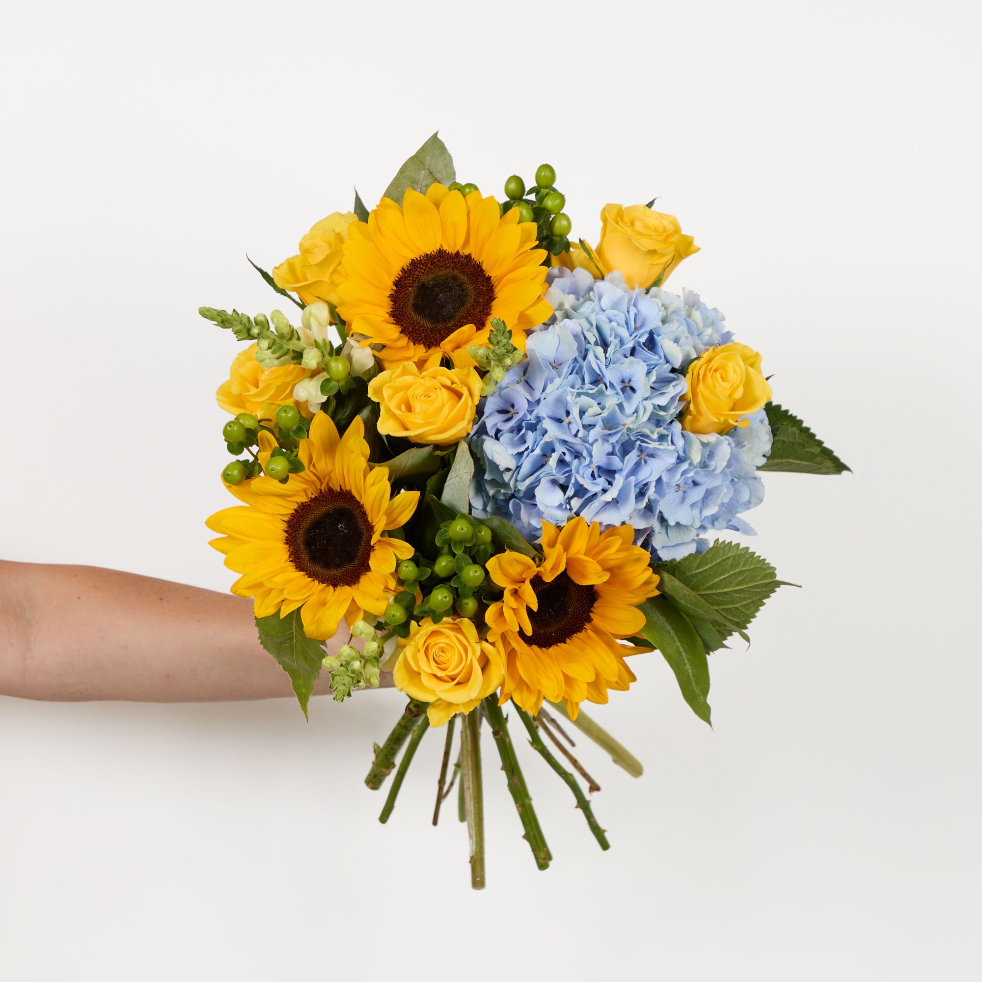 Blue hydrangea, sunflowers, yellow roses, green hypericum, white antirrhinums, eucalyptus robusta