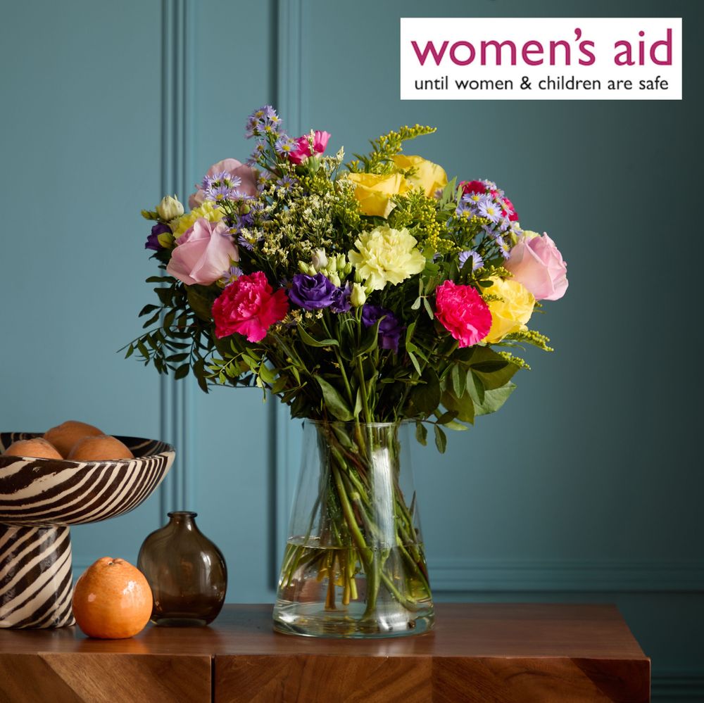 A picture of a colourful bouquet of roses and carnations with the Women's Aid logo in the corner
